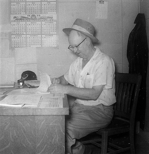 1959 photo of Joshua Claude Greenwood in his office at the Bradley County Lumber Mill. He was a foreman in the furniture shop.