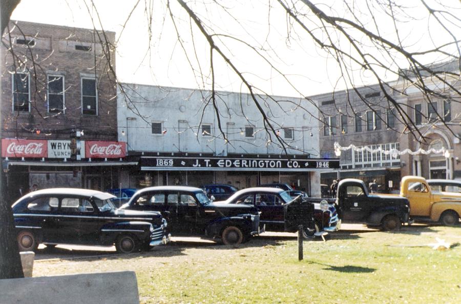 Wayne's and J. T. Ederington Co. in Warren, Arkansas,  and cars parked in front of the Courthouse