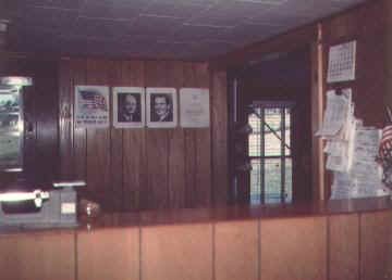 On the wall that there is a picture of both President Richard Nixon and the Postmaster General Winton M. Blount.