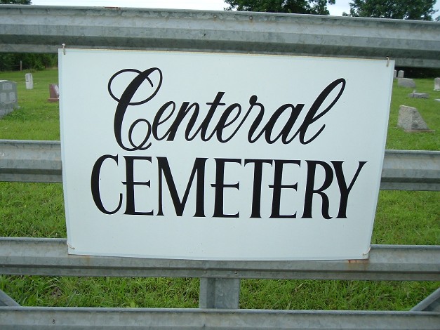 Centeral cemetery, white gate sign with black cursive and block lettering