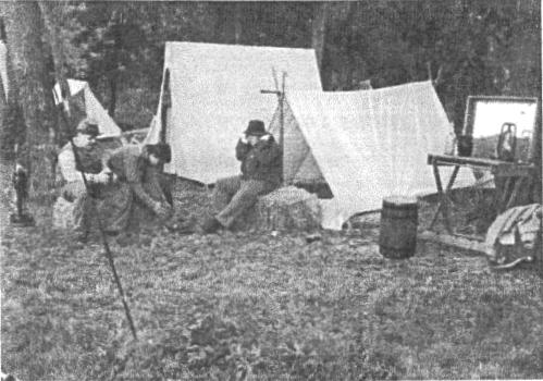 Two soldiers in front of tents