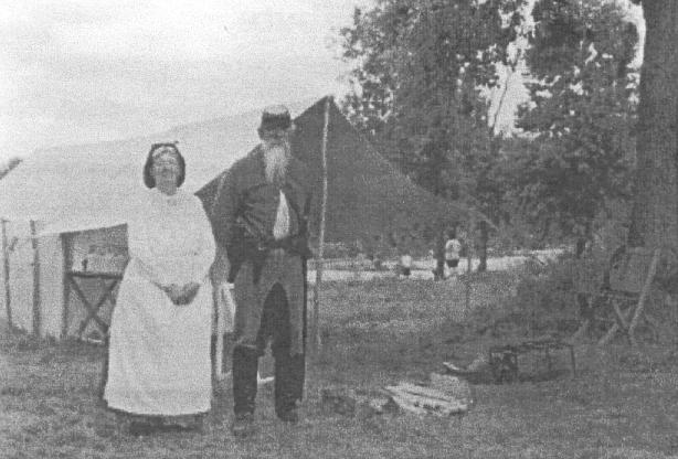 A woman in an aprom & an old soldier with a beard