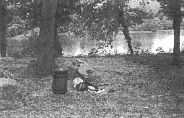 Uniform on hay bale beside creek